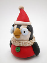 Christmas penguin wearing Santa style outfit