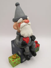 Christmas folk art Santa sitting on gifts holding red heart