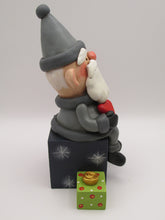 Christmas folk art Santa sitting on gifts holding red heart