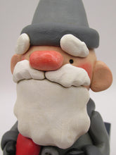 Christmas folk art Santa sitting on gifts holding red heart