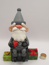 Christmas folk art Santa sitting on gifts holding red heart