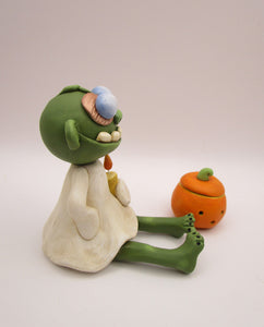 Halloween folk art sitting zombie with removable pumpkin