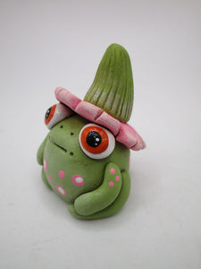 Spring folk art frog wearing pink flower hat with stem 1.75 tall