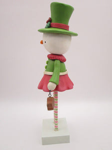 Christmas folk art snowman snow girl with fancy hat and jam sugar cookie