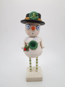 Christmas folk art snowman with black hat and wood legs