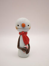 Christmas small snowman flat head and tiny gift in hand