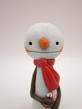 Christmas small snowman flat head and tiny gift in hand