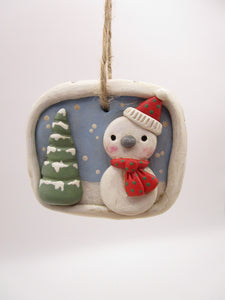 Christmas folk art ornament with snowman scene
