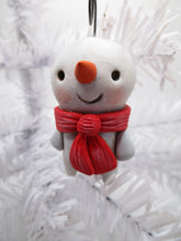 Snowman Christmas ornament with red scarf and carrot nose