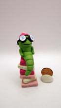 Valentine folk art little bookworm with glasses on stack of famous books