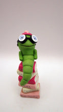 Valentine folk art little bookworm with glasses on stack of famous books