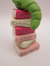 Valentine folk art little bookworm with glasses on stack of famous books