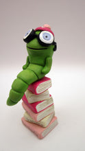 Valentine folk art little bookworm with glasses on stack of famous books