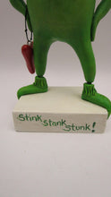 Christmas folk art grinch like standing character with heart charm