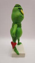 Christmas folk art grinch like standing character with heart charm