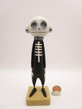 Halloween folk art spooky swirl eye character in skeleton suit