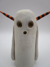 Halloween folk art spooky ghost with orange and black horns