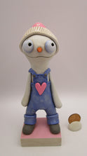 Valentine folk art snowman wearing "denim" like overalls