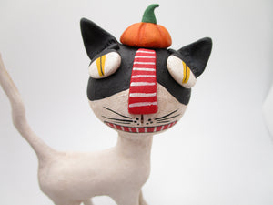 Halloween folk art black and mostly white cat with pumpkin hat
