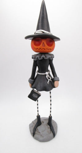 Halloween pumpkin girl wearing witch attire and hat