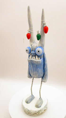 Christmas folk art YETI with string of 