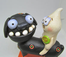 Halloween folk art black dog and ghost rider with candy