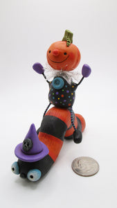 Halloween folk art Pumpkin man riding Halloween color caterpillar