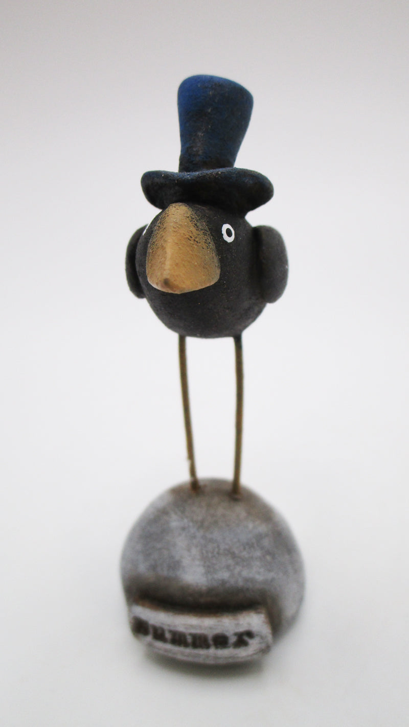 Small 4th of July crow with blue top hat on mounded base with 