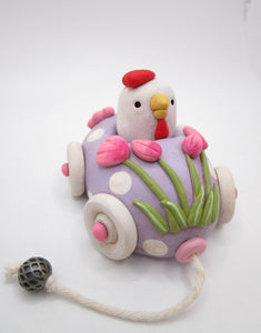 Easter folk art egg shaped car with chicken rider