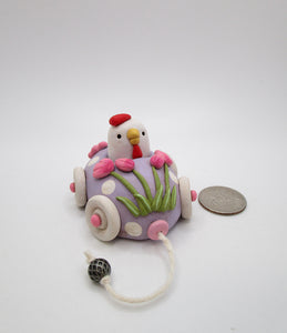 Easter folk art egg shaped car with chicken rider