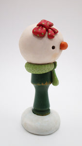Christmas folk art style snowman - snow girl with bow and vintage game piece for body