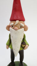 Woodland old fashion fable gnome with acorn in hand