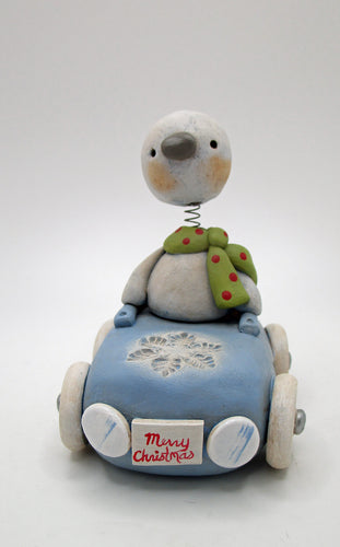 Christmas bobble head snowman riding a snowflake themed car