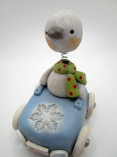 Christmas bobble head snowman riding a snowflake themed car