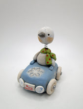 Christmas bobble head snowman riding a snowflake themed car