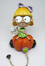 Halloween folk art blonde girl with candy and spooky ghost on pumpkin