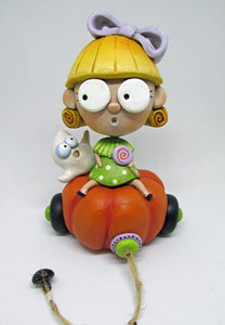Halloween folk art blonde girl with candy and spooky ghost on pumpkin