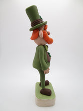 St Patrick's day leprechaun with top hat and four leaf clover bouquet