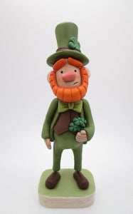 St Patrick's day leprechaun with top hat and four leaf clover bouquet