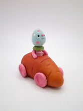 Easter folk art little carrot car with Easter egg man rider