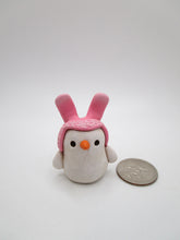 Mini Easter snowman wearing pink bunny ear hat