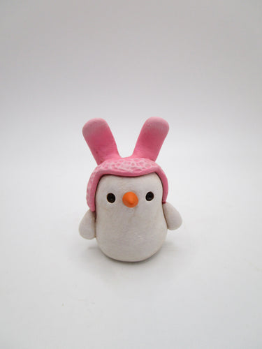 Mini Easter snowman wearing pink bunny ear hat