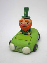 St. Patrick's day tiny leprechaun riding in a green clover decor car
