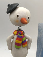 Christmas folk art artist snowman and his painting with brush and easel