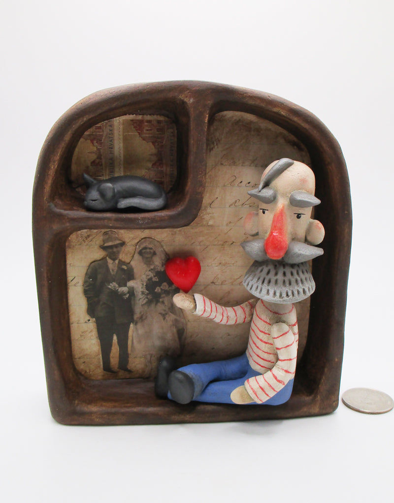 Handcrafted collage box with folk art man sitting inside with cat and love - paper clay