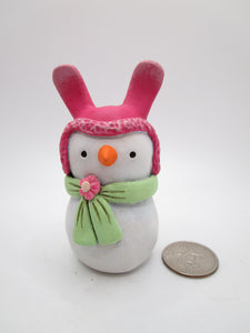 Paper clay Easter snowman wearing a bunny hat and spring scarf