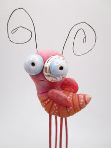 Spring time pink bug with four legs and fancy painted base