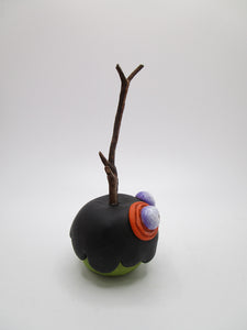 Halloween folk art black poison candy apple with bug eyes