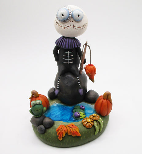 Halloween folk art Skelly fishing in the pond in autumn