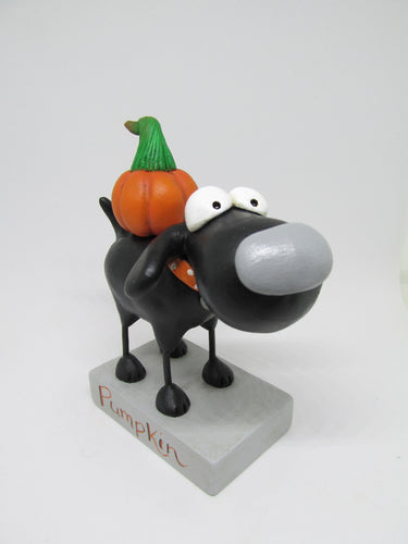 Halloween black dog with pumpkin on his back
